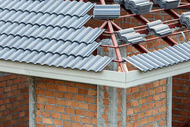 damaged roof with emergency roof tarp | roofing insurance claims in New Orleans