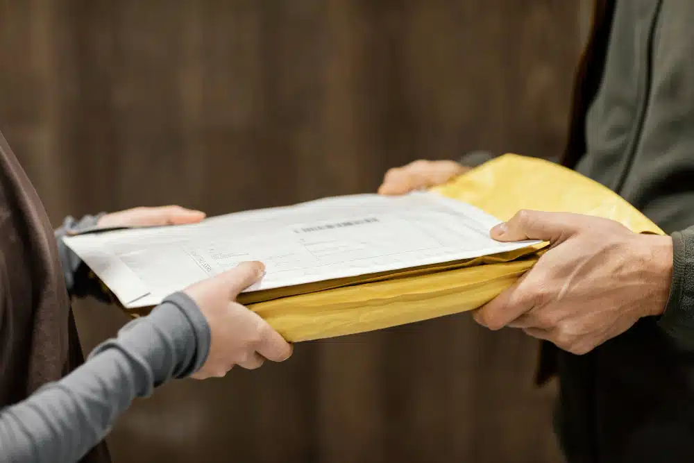 insurance papers being handed over to another person