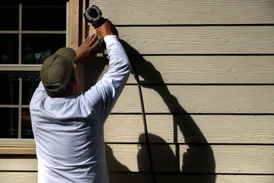 carpenter installing a siding