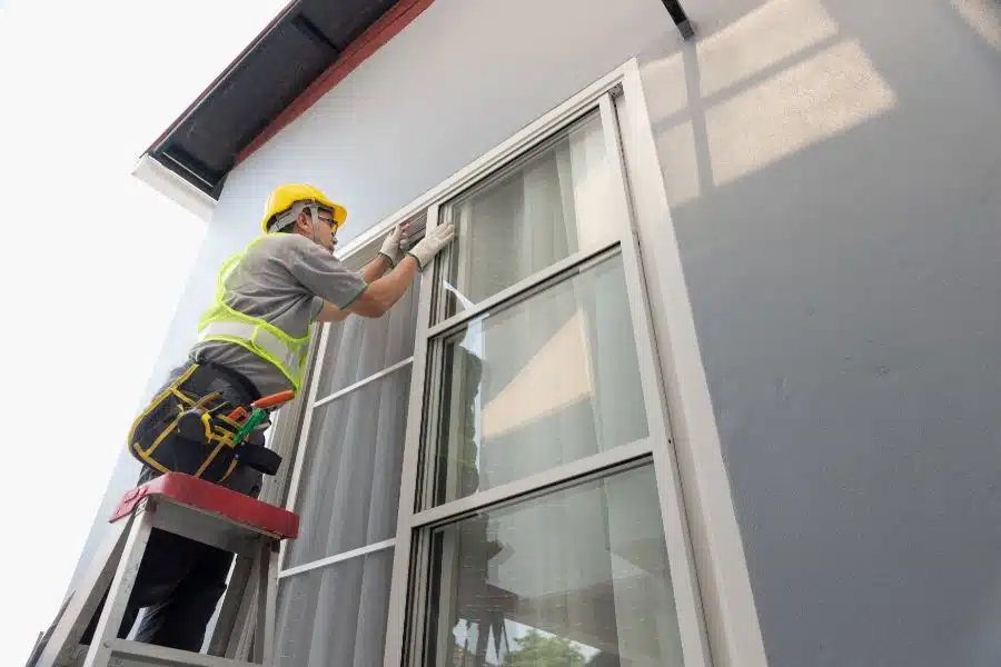 Construction worker repairing sliding window