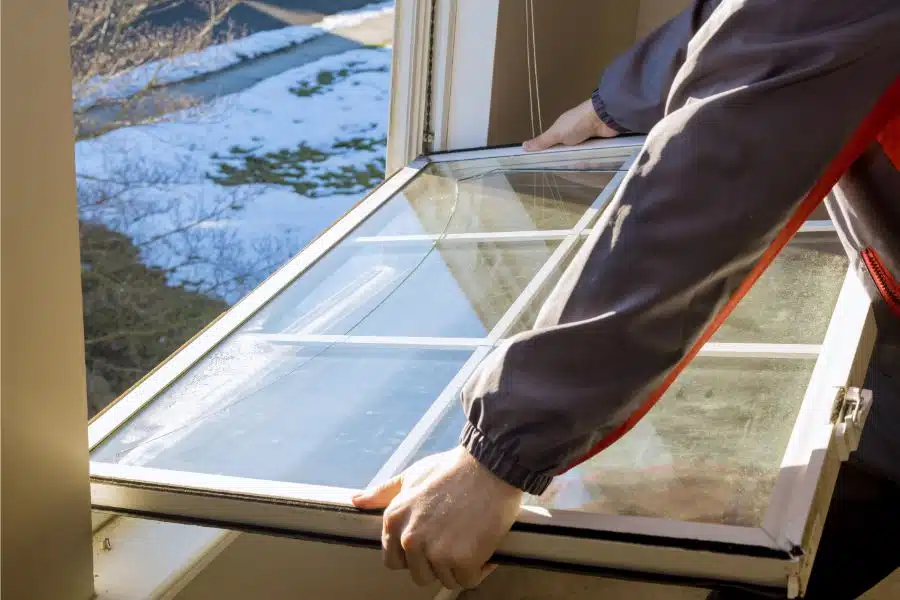 Construction worker replacing a window