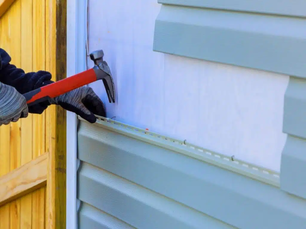 a construction worker replacing a siding