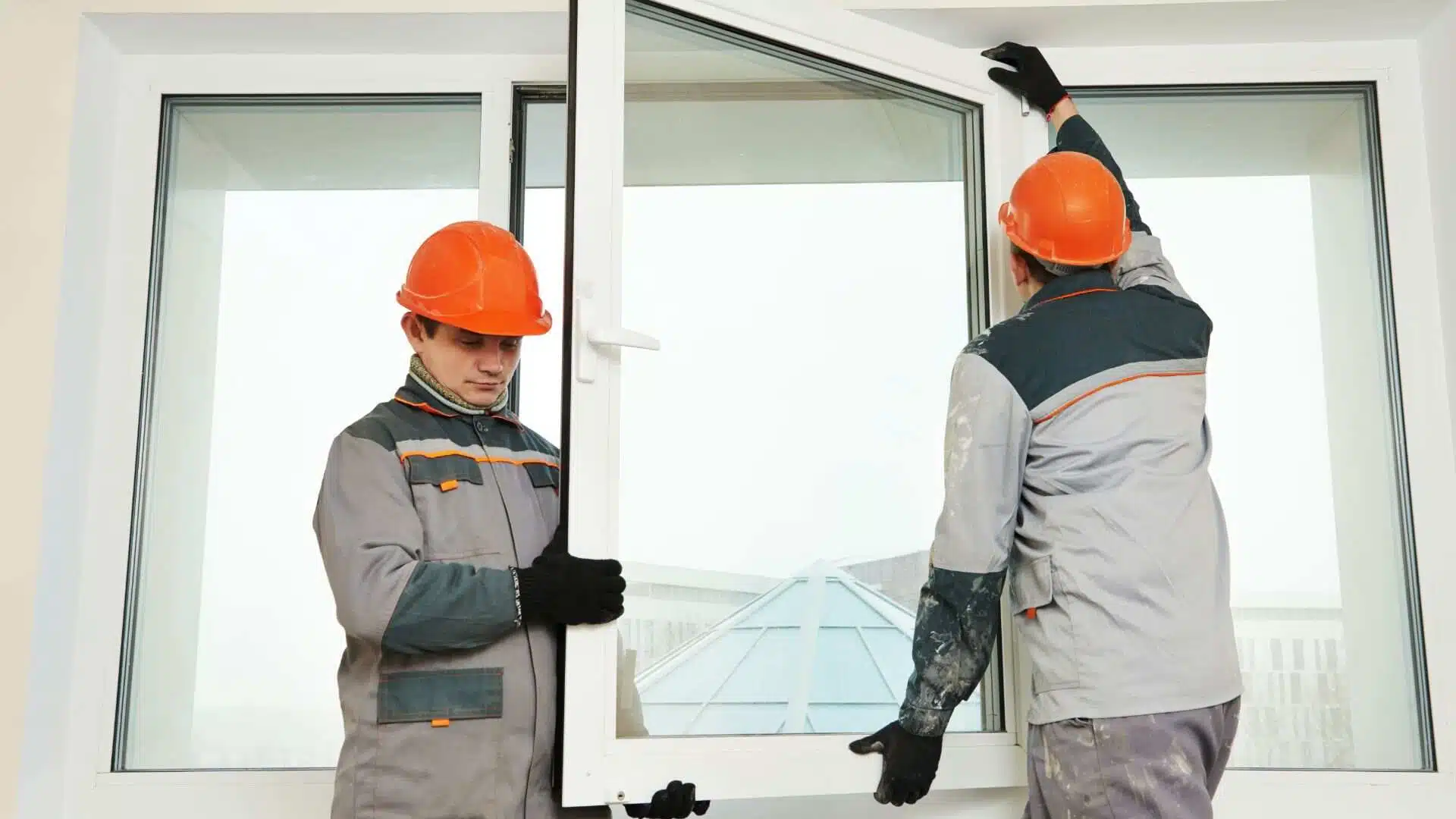 two workers installing window