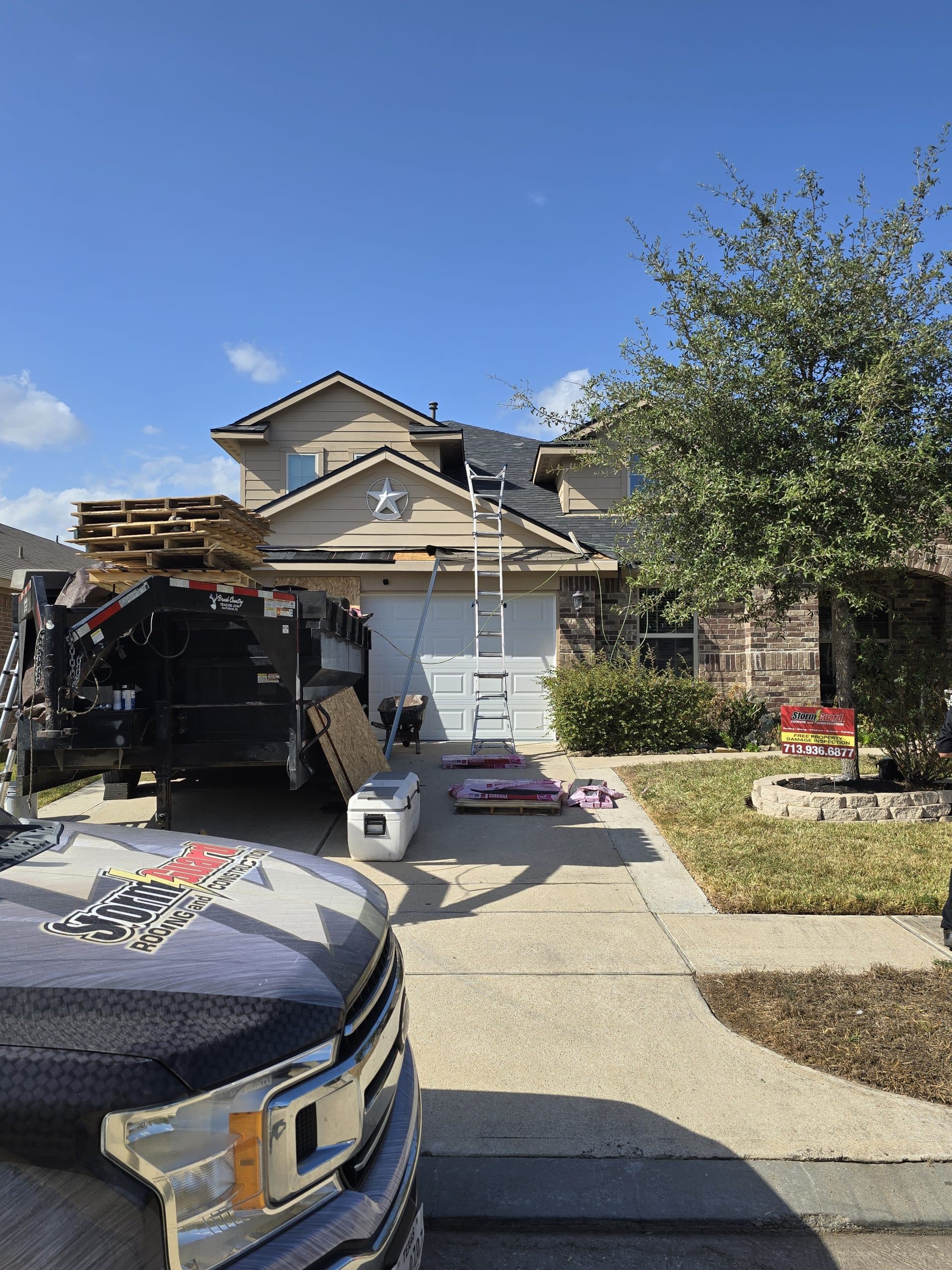 Brick House with Storm Guard Restoration Services Truck In Driveway